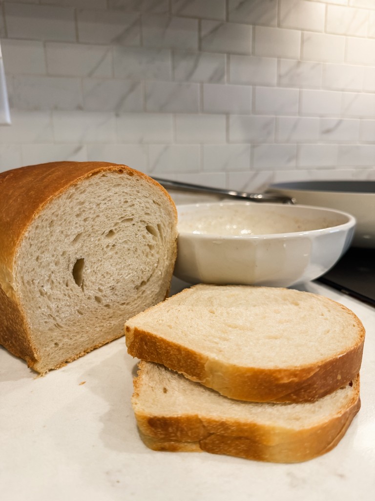 A sliced sourdough sandwich loaf showing its soft crumb